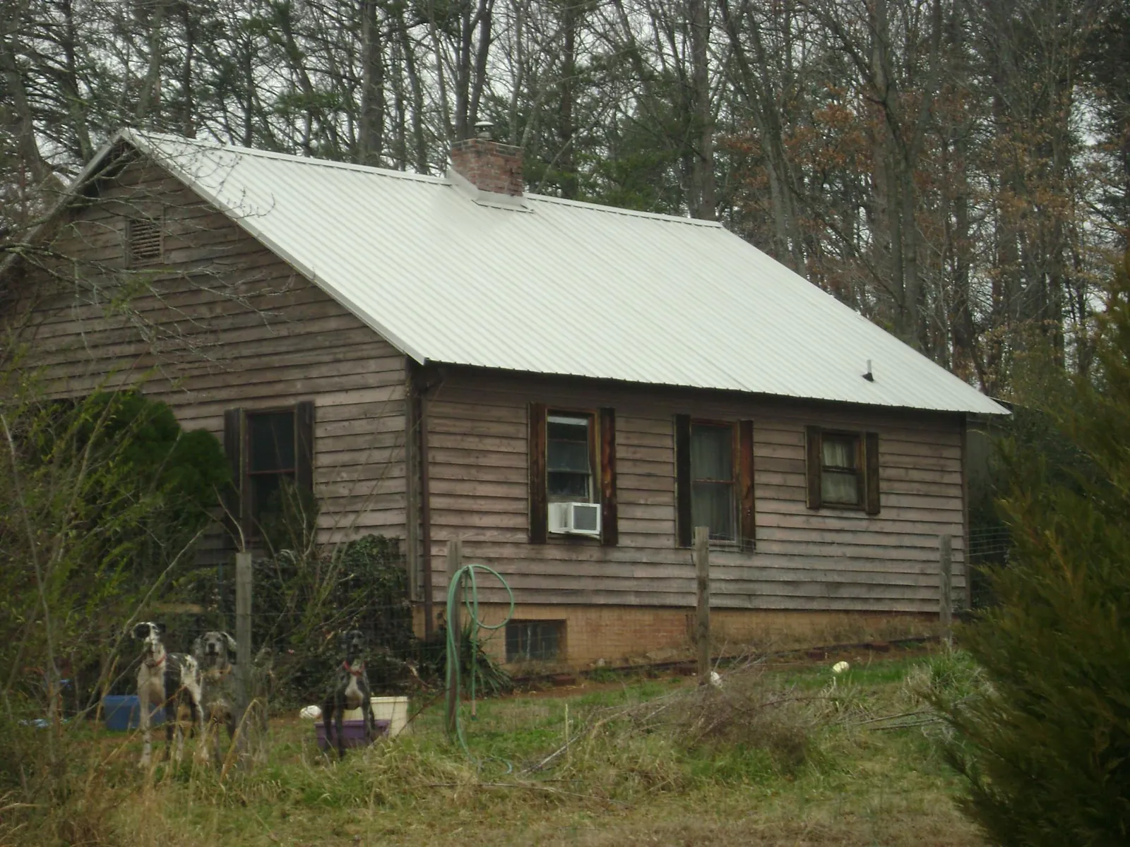 White metal roof on an old wood sided farmhouse, from a Asphalt Shingle Roof Repair job in Sullivan